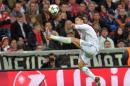 Real's Cristiano Ronaldo jumps for the ball during the Champions League semifinal second leg soccer match between Bayern Munich and Real Madrid at the Allianz Arena in Munich, southern Germany, Tuesday, April 29, 2014. (AP Photo/Kerstin Joensson)