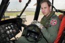 A handout file photograph shows Britain's Prince William in the cockpit of his helicopter after qualifying as a search and rescue captain, in Anglesey, Wales