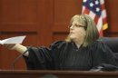 Judge Debra Nelson hands the verdict to the clerk of courts announcing George Zimmerman is not guilty in the 2012 shooting death of Trayvon Martin at the Seminole County Criminal Justice Center in Sanford Florida