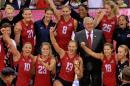 United States' Christa Harmotto Dietzen (13) holds the championship trophy as she poses with teammates for a photo after a 3-0 win over China and winning the women's FIVB World Grand Prix volleyball championship in Omaha, Neb., Sunday, July 26, 2015. Also in the photo are Jordan Larson-Burbach (10), Kelsey Robinson (23), Molly Kreklow (18), Tetori Dixon (21), Lauren Gibbemeyer (8) and Karsta Lowe (25). (AP Photo/Nati Harnik)