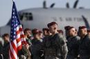 Members of the U.S. Army 173rd Airborne Brigade attend a welcome ceremony upon their arrival by plane at a Lithuanian air force base in Siauliai, Lithuania, Saturday, April 26, 2014. US troops arrived Saturday in Lithuania to participate in NATO maneuvers, at a time of increased tension in nearby Ukraine.(AP Photo/Mindaugas Kulbis)