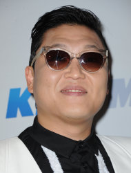 FILE - In this Monday, Dec. 3, 2012 file photo, PSY arrives at KIIS FM's Jingle Ball at Nokia Theatre LA Live, in Los Angeles. President Barack Obama still intends to attend a charity concert where PSY is scheduled to perform after reports the South Korean rapper participated in anti-American protests several years ago. (Photo by Katy Winn/Invision/AP, File)
