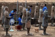 This picture taken on June 9, shows Chinese archaeologists at work in the extended excavation site at the Terracotta Warriors and Horses Museum in Xian. Chinese archaeologists have unearthed 110 new terracotta warriors that laid buried for centuries, part of the famed army built to guard the tomb of China's first emperor