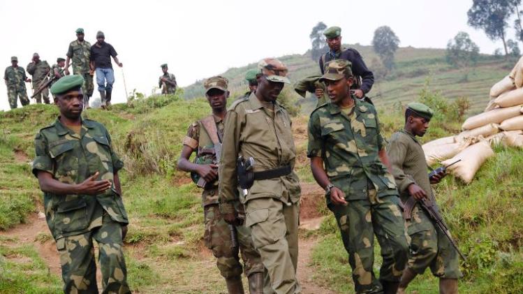 Colonel Sultani Makenga (3rd left), head of the rebel M23 group, walks on a hill in Bunagana, a town near the Ugandan border, on July 8, 2012