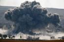 An explosion following an air-strike is seen in the Syrian town of Kobani during heavy fighting