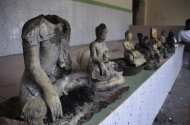 Damaged statues at a Buddhist temple that was torched in Ramu in the coastal district of Cox's Bazar, Bangladesh, Sunday, Sept. 30, 2012. Thousands of Bangladeshi Muslims angry over an alleged derogatory photo   of the Islamic holy book Quran on Facebook set fires in at least 10 Buddhist temples and 40 homes near the southern border with Myanmar, authorities said Sunday. (AP Photo)