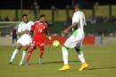 Nigeria's midfielder John Obi Mikel (L) defends against Sudan's Muhannad El Tahir (C) during the 2015 African Cup of Nations qualifying football match in Khartoum on October 11, 2014
