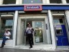 A man comes out of an Eurobank branch in central Athens