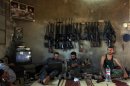 FILE - In this June 12, 2012 file photo, Free Syrian Army fighters sit in a house on the outskirts of Aleppo, Syria. More than 100,000 people have been killed since the start of Syria's conflict over two years ago, an activist group said Wednesday. (AP Photo/Khalil Hamra, File)
