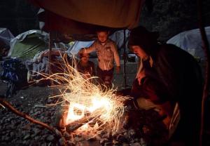 An Afghan migrant and a child warm up by a fire at&nbsp;&hellip;