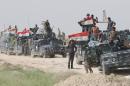 Iraqi pro-government forces gather in al-Shahabi village, east of the city of Fallujah, on May 24, 2016, as part of a major assault to retake the city from Islamic State group