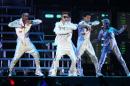 Canadian pop singer Justin Bieber, center, performs on stage during the first Australian stop of his Believe tour at the Entertainment Centre in Brisbane, Australia, Wednesday, Nov. 27, 2013. (AP Photo/Tertius Pickard)