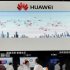 People visit the Huawei booth at a communication technologies exhibition in Beijing