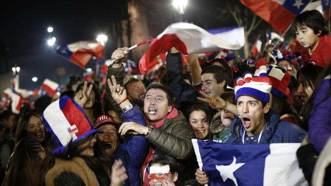 Fans of Chile&#39;s national soccer team celebrate after their team defeated Peru during a Copa America semifinal soccer match, in Concepcion, Chile, Monday, June 29, 2015. Chile won 2-1. (AP Photo/Silvia Izquierdo)