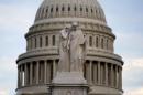 The statue of Grief and History stands in front of the Capitol Dome in Washington