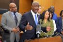 Fulton County District Attorney Paul Howard, center, holds a press conference following the conviction of 11 of 12 defendants in the Atlanta Public Schools test cheating case Wednesday, April 1, 2015 in Atlanta. A jury of six men and six women rendered their verdicts in the Atlanta Public Schools test-cheating trial on Wednesday, April 1, 2015. Jurors sorted through roughly five months of testimony against 12 former educators accused of engaging in a racketeering conspiracy to inflate test scores. (AP Photo/Atlanta Journal-Constitution, Kent D. Johnson, Pool)