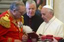 Pope Francis exchange gifts with the Grand Master of the Sovereign Order of Malta, Fra' Matthew Festing, during a private audience in the pontiff's private library at the Vatican, Friday, June 20, 2014. (AP Photo/Claudio Peri, Pool)