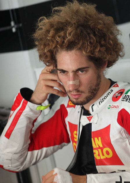 In this picture taken Saturday, Oct. 22, 2011, MotoGP rider Marco Simoncelli, of Italy, looks on during the official practice of the Malaysian MotoGP Grand Prix in Sepang, Malaysia. The Malaysian Moto