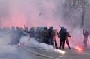 Anti-riots policemen stand in the smoke during clashes on the sidelines of a demonstration against Italian government and austerity measures on April, 2014 in Rome