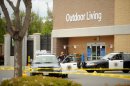 Police cars maintain a perimeter around a San Jose, Calif., Walmart after a motorist drove through a store entrance and began assaulting shoppers on Sunday, March 31, 2013. Four people sustained injuries during the attack according to a police spokesman. (AP Photo/Noah Berger)