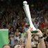 Ferrer celebrates by raising the trophy after beating Kohlschreiber during their men's singles final match at the Heineken Open in Auckland