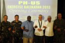 Philippine foreign secretary Rosario and U.S. ambassador to the Philippines Thomas link arms with other military officials during the opening ceremony of annual Philippines-U.S. military exercise at Camp Aguinaldo in Quezon city,