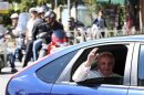 Pope Francis waves from a car as he leaves at the end of his visit to the Basilica of Saint John Lateran in Rome