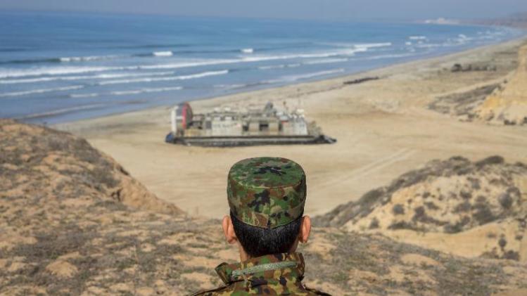 A Japanese soldier watches a joint exercise between the Japanese and United States militaries outside the USMC base in Camp Pendleton, California, on February 19, 2014