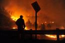 Firefighter Carl Schwettmann looks out towards approaching flames during the Rocky fire near Clear Lake, California on August 2, 2015