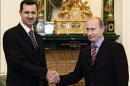 FILE - In this Tuesday, Dec. 19, 2006 file photo Vladimir Putin, then Russian President, right, and his Syrian counterpart Bashar Assad smile as they shake hands in Moscow's Kremlin. With even his most powerful ally, Russia, losing faith in him, President Bashar Assad may appear to be heading for a last stand against rebel forces who have been waging a ferocious battle to overthrow him for nearly two years. But Assad still has thousands of elite and loyal troops behind him, and analysts say that even if he wanted to give up the fight, it's unclear those around him would let him abandon ship and leave them to an uncertain fate.(AP photo/RIA Novosti, Mikhail Klimentyev, Presidential Press service, File)