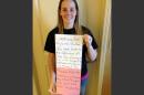 This March 2, 2014 photo provided by Katheryn Deprill that she posted on Facebook, shows her holding a sign that says she is seeking her birth mother. Deprill was abandoned in the bathroom of a Burger King restaurant in Allentown, Pa., when she was a few hours old. (AP Photo/Courtesy of Katheryn Deprill)