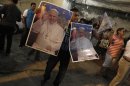 A man sells posters with the Pope's photo during the visit of the World Youth Day cross in the Rocinha slum in Rio de Janeiro