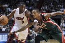Miami Heat's Wade moves against Milwaukee Bucks' Ellis during their NBA basketball game in Miami