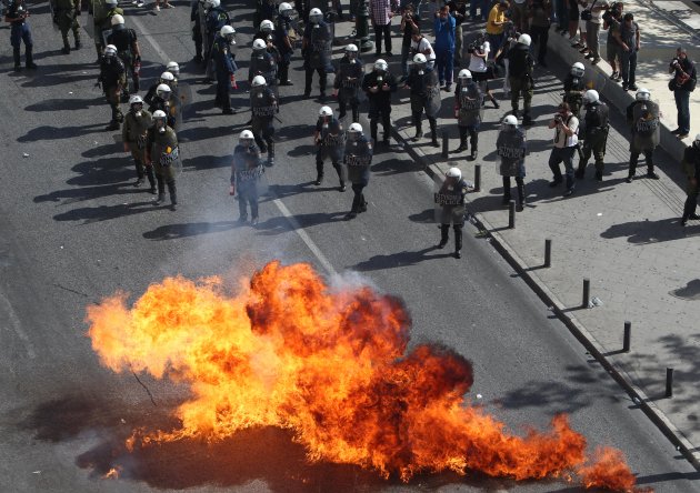 Protesters throw petrol bombs against riot police during a 24-hour nationwide general strike, Athens, Thursday, Oct. 18, 2012. Greece was facing its second general strike in a month Thursday as workers protested over another batch of austerity measures that are designed to prevent the bankruptcy of the country. (AP Photo/Thanassis Stavrakis)