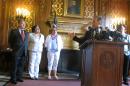 Republican Assembly Speaker Robin Vos, right, motions to Democratic Reps., from left: Peter Barca; JoCasta Zamarripa and Christine Sinicki at a news conference to announce a bill to pay for a new $500 million Milwaukee Bucks arena will pass on Tuesday, July 28, 2015, in Madison, Wis. (AP Photo/Scott Bauer)
