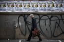 A man walks past posters advertising a New Years Eve party in Tel Aviv, Israel, Monday, Dec. 30, 2013. In Israel, the somber, soul-searching and autumnal new year of the lunar Jewish calendar overshadows the Gregorian's Jan. 1. (AP Photo/Oded Balilty)