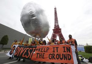 Protestors with a giant silver baloon which symbolizes&nbsp;&hellip;