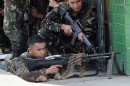 Philippine troops take cover from enemy snipers in Zamboanga on the southern island of Mindanao, on September 11, 2013