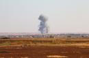 A picture taken on September 1, 2015 shows smoke billowing on the outskirts of Marea in the northern Syrian Aleppo district, during fighting between opposition fighters and Islamic State group