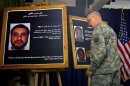 A U.S. solider shows a picture of Ali Mussa Daqduq during a news conference at the heavily fortified Green Zone area in Baghdad