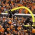 A fan hangs from a goal post after it was torn down in celebration of Oklahoma State's 44-10 win over Oklahoma in an NCAA college football game in Stillwater, Okla., Saturday, Dec. 3, 2011. (AP Photo/Sue Ogrocki)