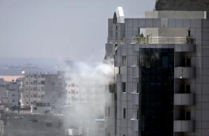 Smoke rises from a building was hit with an Israeli &hellip;