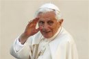 File photo of Pope Benedict XVI waving as he arrives to lead the Wednesday general audience in Saint Peter's square at the Vatican