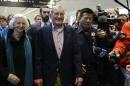 Merrill Newman, center, walks beside his wife Lee after arriving at San Francisco International Airport on Saturday, Dec. 7, 2013. Newman was detained in North Korea late October at the end of a 10-day trip to North Korea, a visit that came six decades after he oversaw a group of South Korean wartime guerrillas during the 1950-53 war. He was released from North Korea early Saturday. (AP Photo/Ben Margot)