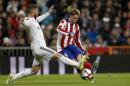 Real Madrid's Sergio Ramos, left, duels for the ball with Atletico de Madrid Fernando Torres during a King's Cup soccer match between Atletico de Madrid and Real Madrid, at the Santiago Bernabeu stadium in Madrid, Spain, Thursday, Jan. 15, 2015. (AP Photo/Daniel Ochoa de Olza)