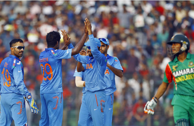 India’s Varun Aaron, second left, celebrates with teammates the dismissal of Bangladesh’s Anamul Haque during the Asia Cup one-day international cricket tournament in Fatullah, near Dhaka, Bangladesh,