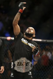 Demetrious Johnson celebrates one of his many wins in the Octagon. (AP)