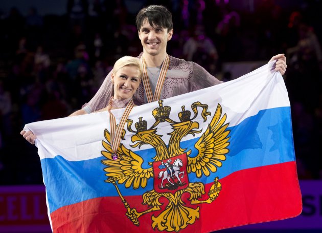 Gold medalists Tatiana Volosozhar and Maxim Trankov from Russia, pose with their medals and flag during victory ceremonies in the pairs competition at the World Figure Skating Championships Friday, March 15, 2013 in London, Ontario. (AP Photo/The Canadian Press, Paul Chiasson)