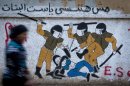 An Egyptian woman passes by a new mural inspired by a widely circulated photo of Egyptian police beating and stripping a veiled female protester, on a recently whitewashed wall in Tahrir Square, Cairo, Egypt, Friday, Sept. 28, 2012. The Arabic writing reads, "we will not forget you."(AP Photo/Khalil Hamra)