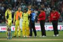 Australia's Mitchell Marsh (L) and Matthew Wade (3rd L) with Brendon McCullum of New Zealand (3rd R) await the umpires decision during the third one-day international cricket match on February 8, 2016